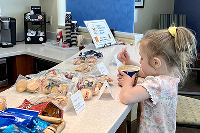 Toddler enjoying a snack while hanging out at RMHC-Denver Family Room