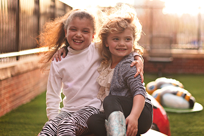 RMHC family - two girls playing on playgroudn