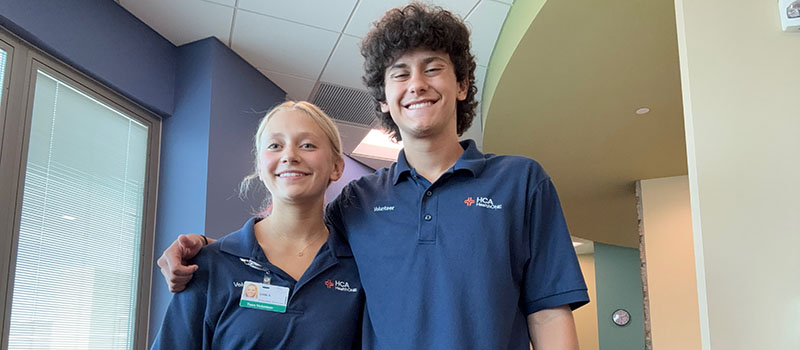 Brady & sister volunteering in Family Room