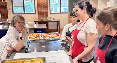 Chef Torie and Chef Mary with meal group