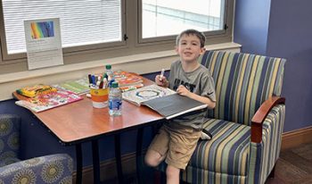 Young boy doing finding fun at RMCH-Denver Family Room