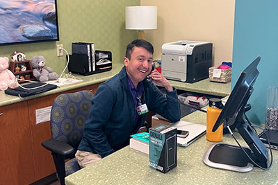 Volunteer answering questions about the amenities at RMHC-Denver Family Room