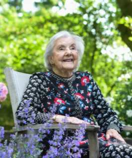 Audrey Evans sitting in her garden